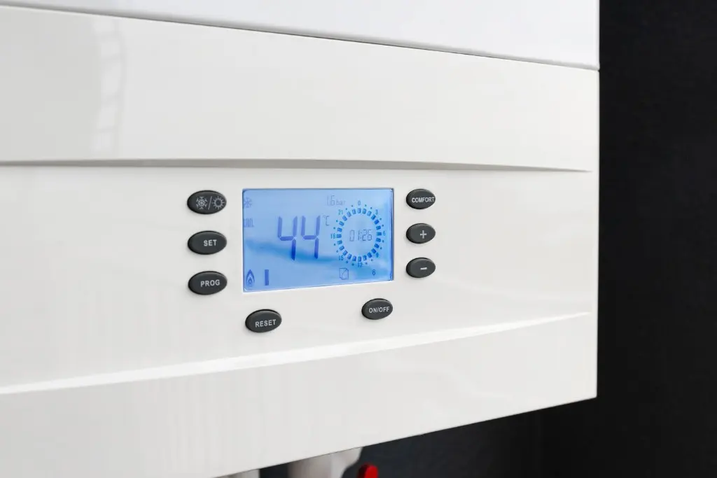 Modern white gas boiler control panel with digital temperature display, a typical UK domestic boiler still legal to replace in existing homes in 2026