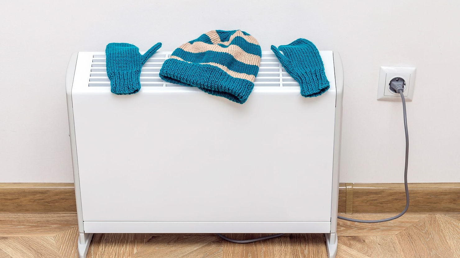 Woolly hat and gloves drying on a radiator